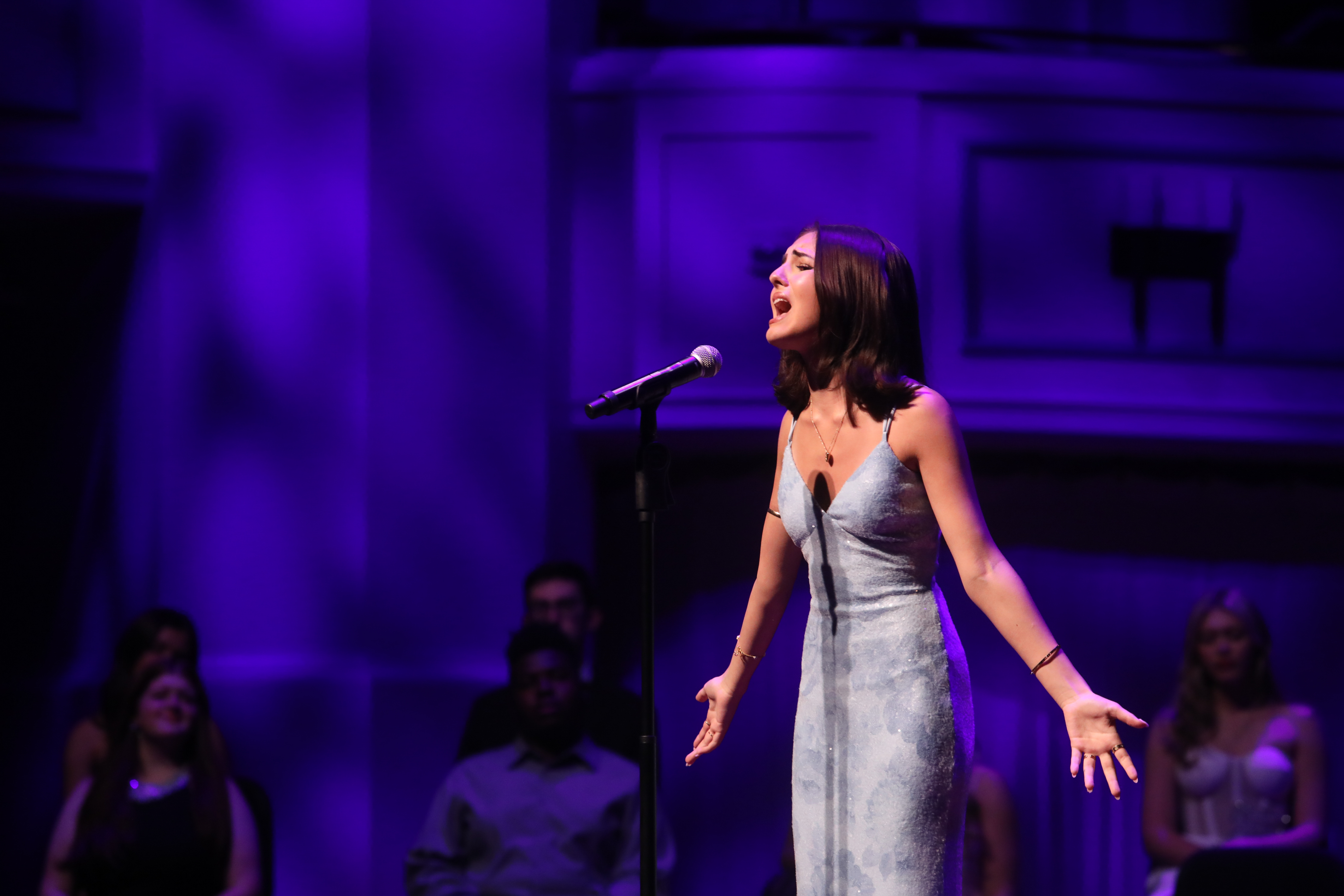 Kellyssa Rose Vincent singing with arms open